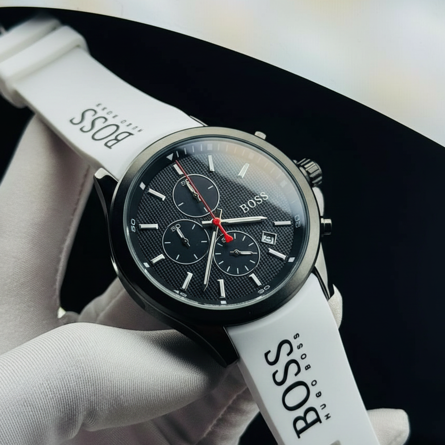 BOSS watch with white strap held by a gloved hand against a black background